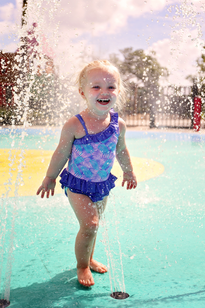 little girl on splash pad